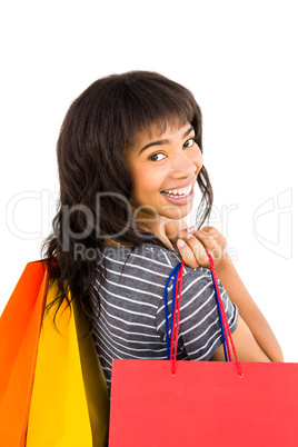 Rear view of a casual woman holding shopping bags