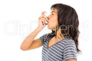 Casual woman using her inhaler