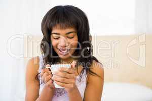 Casual woman holding a cup of coffee