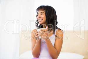 Casual smiling woman holding a cup of coffee