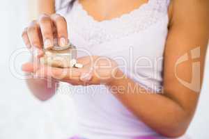 Casual woman holding a box of pills