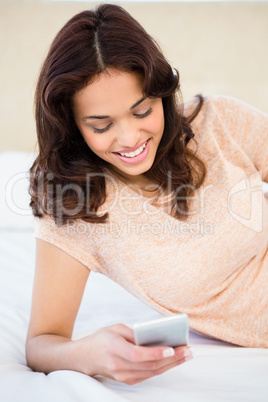 Casual smiling woman using her smartphone