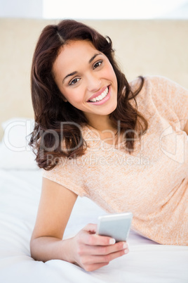 Casual smiling woman using her smartphone