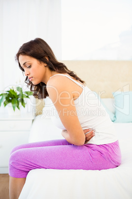 Side view of a woman with a belly pain