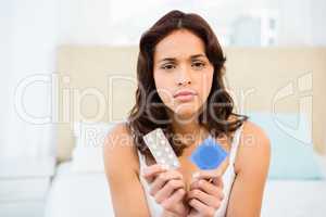 Concerned woman looking at contraception
