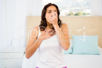 Side view of a woman using her inhaler