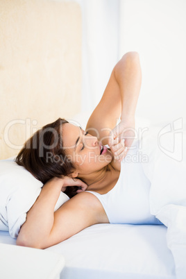 Asleep woman lying on her bed