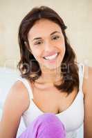 Smiling woman sitting on the bed