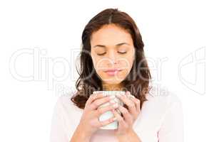 Woman with eyes closed holding mug