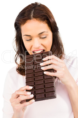 Casual woman crunching bar of chocolate