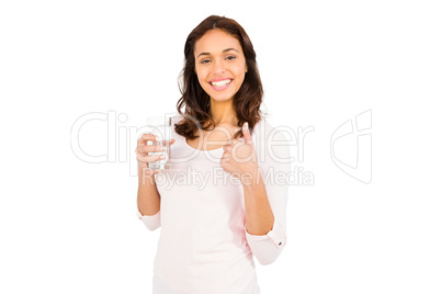 Smiling woman with thumbs up holding glass of water
