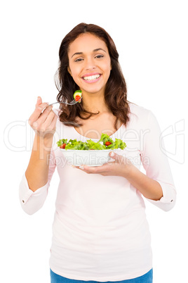 Pretty smiling woman eating salad