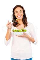 Pretty smiling woman eating salad