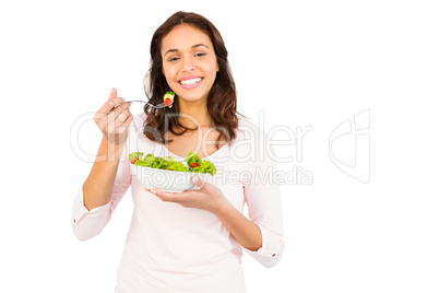 Pretty smiling woman eating salad