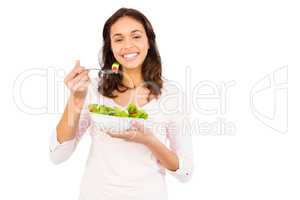 Pretty smiling woman eating salad