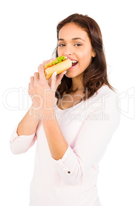Smiling woman eating sandwich