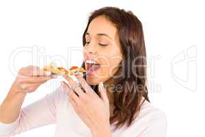 Smiling woman eating a slice of pizza