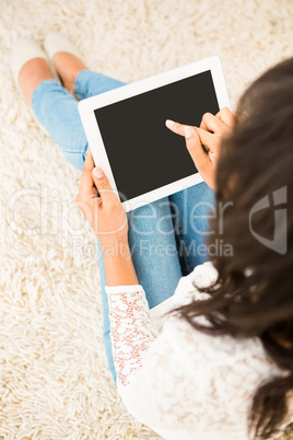 Over shoulder view of woman using tablet