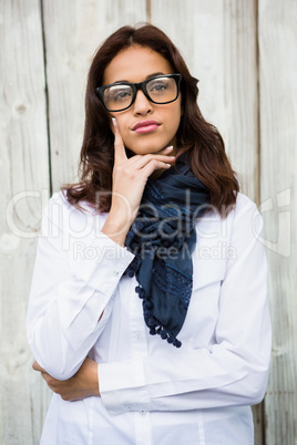 Thoughtful hipster woman with hand on chin