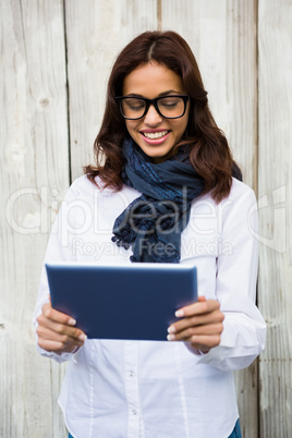 Smiling woman using digital tablet