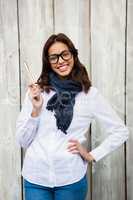 Smiling hipster woman holding paintbrush