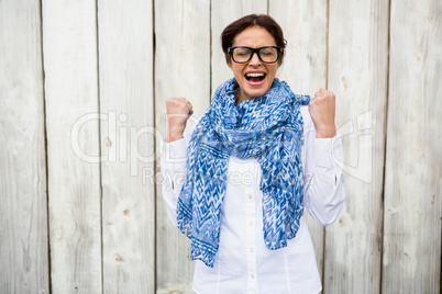 Happy hipster woman celebrating victory