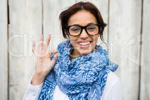 Smiling hipster woman doing the ok sign