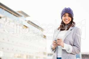 Smiling woman using mobile phone