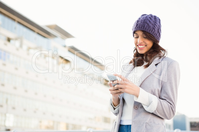 Smiling woman using mobile phone