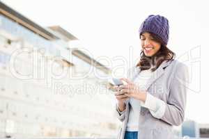 Smiling woman using mobile phone