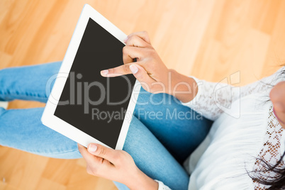 Woman using digital tablet on floor