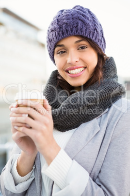 Smiling woman with take-away coffee