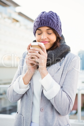 Smiling woman with take-away coffee