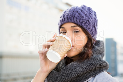 Smiling woman with take-away coffee