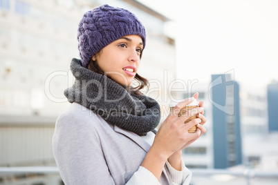 Smiling woman with take-away coffee