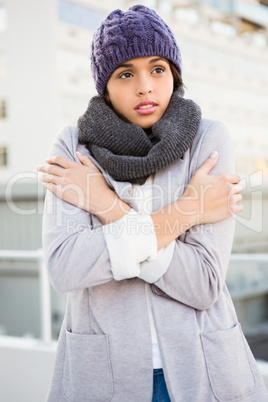 Thoughtful woman in winter coat trembling