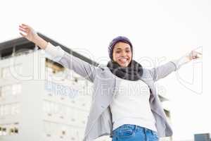 Happy woman raising her hands up