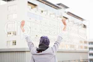 Happy woman raising her hands up