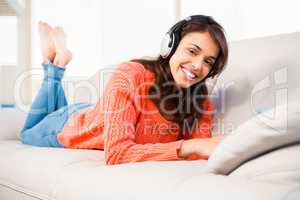 Smiling woman listening music while using her tablet