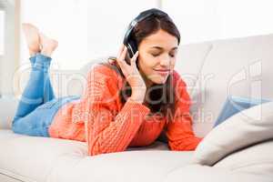 Smiling woman listening music while using her tablet