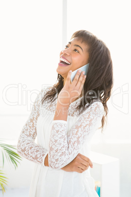 Smiling woman having a phone call in living room