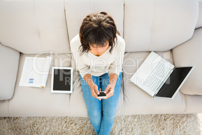 Smiling woman texting on her smartphone