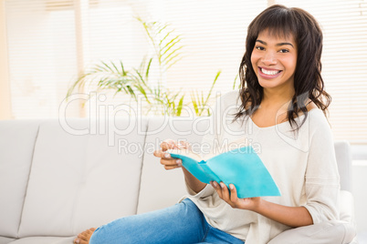 Pretty woman reading on couch