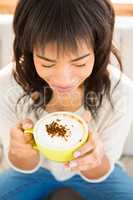 Pretty woman enjoying a cappuccino