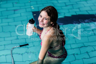 Fit woman cycling in the pool