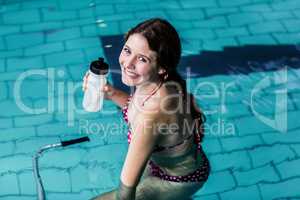 Fit woman cycling in the pool