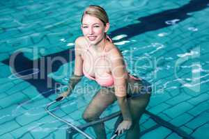 Fit woman cycling in the pool