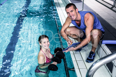 Smiling fit woman doing aqua aerobics