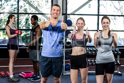 Women and trainer with thumbs up