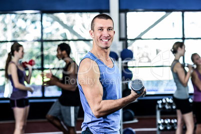 Fit man lifting black dumbbells